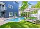 Resort style private backyard with pool, lounge chairs, and lush landscaping at 159 Crescent Dr, Anna Maria, FL 34216