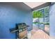 Backyard patio with a spiral staircase, a grill, and a partial view of a manicured lawn and a sparkling pool at 159 Crescent Dr, Anna Maria, FL 34216