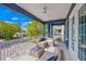 Comfortable outdoor balcony featuring cozy seating and a ceiling fan, perfect for relaxation and enjoying outdoor views at 159 Crescent Dr, Anna Maria, FL 34216