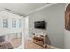 Neutral painted bonus bedroom featuring tile flooring, a flatscreen television, and a bunkbed at 159 Crescent Dr, Anna Maria, FL 34216