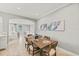 Dining room with modern table set and open access to living room at 159 Crescent Dr, Anna Maria, FL 34216