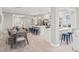 Dining area with modern table set, connected to kitchen with island seating at 159 Crescent Dr, Anna Maria, FL 34216