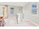 Hallway featuring a staircase, neutral paint, tile flooring, and natural light from many windows at 159 Crescent Dr, Anna Maria, FL 34216