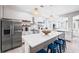 Contemporary kitchen with stainless steel appliances, white cabinets, and island seating at 159 Crescent Dr, Anna Maria, FL 34216
