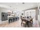 Spacious kitchen and dining area with island and modern lighting at 159 Crescent Dr, Anna Maria, FL 34216