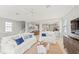 Bright living room with white sofas, open floorplan to kitchen and dining at 159 Crescent Dr, Anna Maria, FL 34216