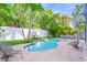 Inviting backyard oasis with a sparkling pool, lush landscaping, and comfortable outdoor seating at 159 Crescent Dr, Anna Maria, FL 34216