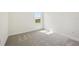 Empty bedroom with gray carpet floors and a large window at 160 Eagleston Ln, Lakewood Ranch, FL 34240