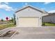 A two-car garage with a neutral door offers convenient parking and storage, blending seamlessly with the home's exterior at 160 Eagleston Ln, Lakewood Ranch, FL 34240