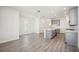 Open floor plan with gray floors, a gray kitchen island, and stainless steel appliances at 160 Eagleston Ln, Lakewood Ranch, FL 34240
