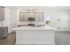 Modern kitchen island with grey cabinets, quartz countertop and stainless steel appliances at 160 Eagleston Ln, Lakewood Ranch, FL 34240
