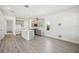 Bright open floor plan features gray floors, stainless appliances, and a gray kitchen island at 160 Eagleston Ln, Lakewood Ranch, FL 34240