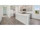 Modern kitchen features a center island, stainless steel appliances and gray cabinetry at 160 Eagleston Ln, Lakewood Ranch, FL 34240
