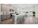 Modern kitchen featuring stainless steel appliances, light gray cabinetry, and a large center island with seating at 160 Eagleston Ln, Lakewood Ranch, FL 34240