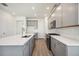 Bright, modern kitchen with stainless appliances, quartz countertops, and stylish gray cabinets at 160 Eagleston Ln, Lakewood Ranch, FL 34240