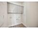 A well-lit laundry room with upper cabinets provides practical storage solutions for household needs at 160 Eagleston Ln, Lakewood Ranch, FL 34240