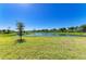 Expansive backyard overlooking a tranquil pond, offering a serene and picturesque setting at 17555 Cantarina Cv, Bradenton, FL 34211