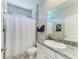 Bright bathroom featuring a granite vanity and shower with bathtub combination at 17555 Cantarina Cv, Bradenton, FL 34211