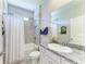 Well-lit bathroom featuring tub-shower combo with decorative granite countertop vanity at 17555 Cantarina Cv, Bradenton, FL 34211