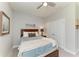 Cozy bedroom featuring a ceiling fan, carpeted floors, and double-door closet at 17555 Cantarina Cv, Bradenton, FL 34211