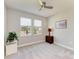 Cozy bedroom with ceiling fan and sunlit windows featuring a view of the outdoors at 17555 Cantarina Cv, Bradenton, FL 34211
