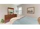 Bedroom featuring carpet, dresser, framed art, and an inviting bed at 17555 Cantarina Cv, Bradenton, FL 34211