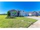 Charming home with stone accents, a spacious three-car garage, and lush landscaping in the front yard at 17555 Cantarina Cv, Bradenton, FL 34211