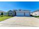 Inviting home with stone accents, a spacious three-car garage, and carefully manicured landscaping in the front yard at 17555 Cantarina Cv, Bradenton, FL 34211