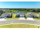 Beautiful single-story homes with well-manicured lawns, long driveways, and a tranquil pond in the background at 17555 Cantarina Cv, Bradenton, FL 34211