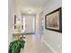 Inviting foyer with neutral walls, decorative light fixtures, and tiled floors leading to the rest of the home at 17555 Cantarina Cv, Bradenton, FL 34211