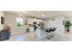 Bright kitchen features stainless appliances, granite countertops, an island with bar seating, and modern pendant lighting at 17555 Cantarina Cv, Bradenton, FL 34211