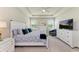 Spacious main bedroom boasts a tray ceiling, large windows with lake views and ample storage at 17555 Cantarina Cv, Bradenton, FL 34211