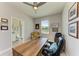 Bright office featuring a ceiling fan, multiple photos, and a large desk at 17555 Cantarina Cv, Bradenton, FL 34211
