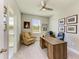 Bright office featuring a ceiling fan, multiple photos, and a large desk at 17555 Cantarina Cv, Bradenton, FL 34211
