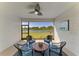 Relaxing screened patio with wicker seating and tranquil water view is perfect for outdoor living at 17555 Cantarina Cv, Bradenton, FL 34211