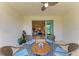 Inviting screened patio with scenic lake view and a cozy seating area, leading to a living room at 17555 Cantarina Cv, Bradenton, FL 34211