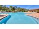 A spacious community pool with lounge chairs and tropical landscaping surrounding the pool at 17555 Cantarina Cv, Bradenton, FL 34211