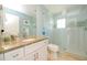 Bathroom featuring a glass shower, granite countertops, and a bright, clean design at 205 17Th N St, Bradenton Beach, FL 34217