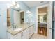 Bathroom with a double sink vanity and granite countertop, with an open view to the main bedroom at 205 17Th N St, Bradenton Beach, FL 34217