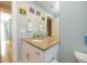 Bathroom with a granite countertop, white cabinetry, and nautical-themed decor at 205 17Th N St, Bradenton Beach, FL 34217