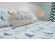 Close-up of a bed featuring a decorative 'believe' pillow and a sailboat-themed quilt at 205 17Th N St, Bradenton Beach, FL 34217