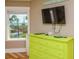 Bright bedroom with a view of the sea, a green dresser, and modern TV at 205 17Th N St, Bradenton Beach, FL 34217