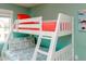 Bedroom with a white bunk bed featuring colorful bedding, offering a fun and functional space at 205 17Th N St, Bradenton Beach, FL 34217