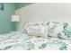 Close-up of a comfortable bed with a 'beach' pillow and a sea-themed bedding at 205 17Th N St, Bradenton Beach, FL 34217