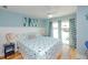 Nautical-themed bedroom with a sailboat patterned quilt, accent pillows, and light blue walls at 205 17Th N St, Bradenton Beach, FL 34217