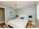 Cozy bedroom with a comfortable queen bed, ceiling fan, and light blue colored walls at 205 17Th N St, Bradenton Beach, FL 34217