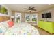 Beautiful bedroom with a view to the sea, colorful floral bedding, and a bright green dresser at 205 17Th N St, Bradenton Beach, FL 34217
