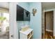 Hallway with an exit to a balcony, a TV, and a coastal-themed decor at 205 17Th N St, Bradenton Beach, FL 34217