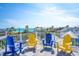 Rooftop deck with colorful Adirondack chairs offers panoramic ocean views and comfortable outdoor living at 205 17Th N St, Bradenton Beach, FL 34217