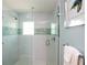 Walk-in shower with glass door, white subway tile, and a decorative tile accent stripe at 205 17Th N St, Bradenton Beach, FL 34217